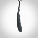A hand carved large Wyoming Black Jade feather necklace. The cord is a black colour and is an adjustable length. A large sized hand made Black Jade feather necklace by New Zealand artist Kerry Thompson. One off work of art to wear.